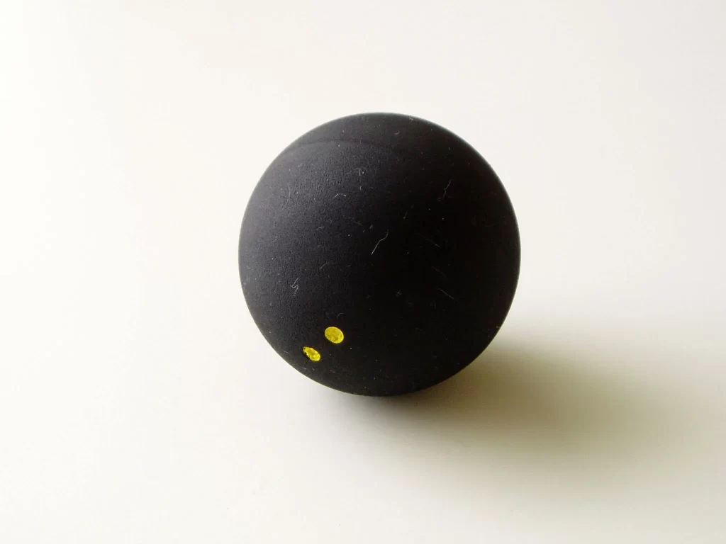 Black Squash Ball with 2 yellow dots
